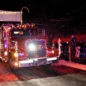 "A fire truck decorated with lights leads the Kiwanis Holiday Lights Parade through Sibley Park on Friday. Photo by John Cross"