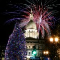Fireworks explode over the state Capitol following a ceremony lighting the official state Christmas tree, Friday, Nov. 22, 2013, in Lansing, Mich. The event was part of the 29th annual Silver Bells in the City celebration. This year's state tree is a 68-foot blue spruce from Iron River in Michigan's Upper Peninsula, donated by John and Barbara Waara. (AP Photo/Al Goldis)