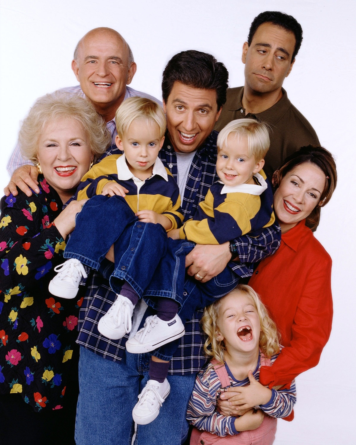 The cast of EVERYBODY LOVES RAYMOND: Ray Romano, center, holding Sawyer and...